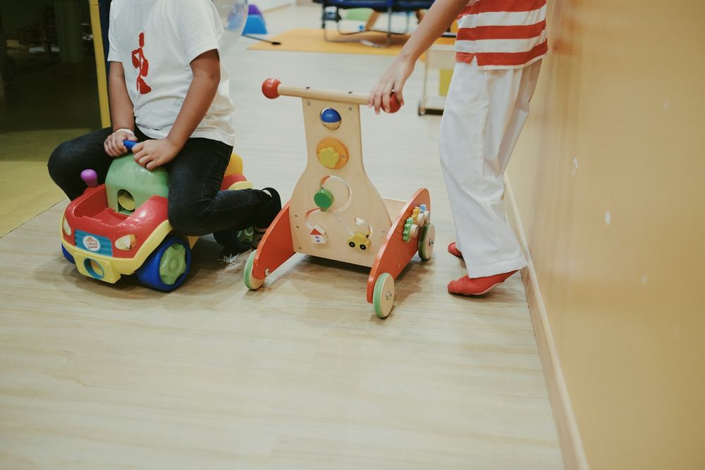 Toddlers playing with ride-on and push toys
